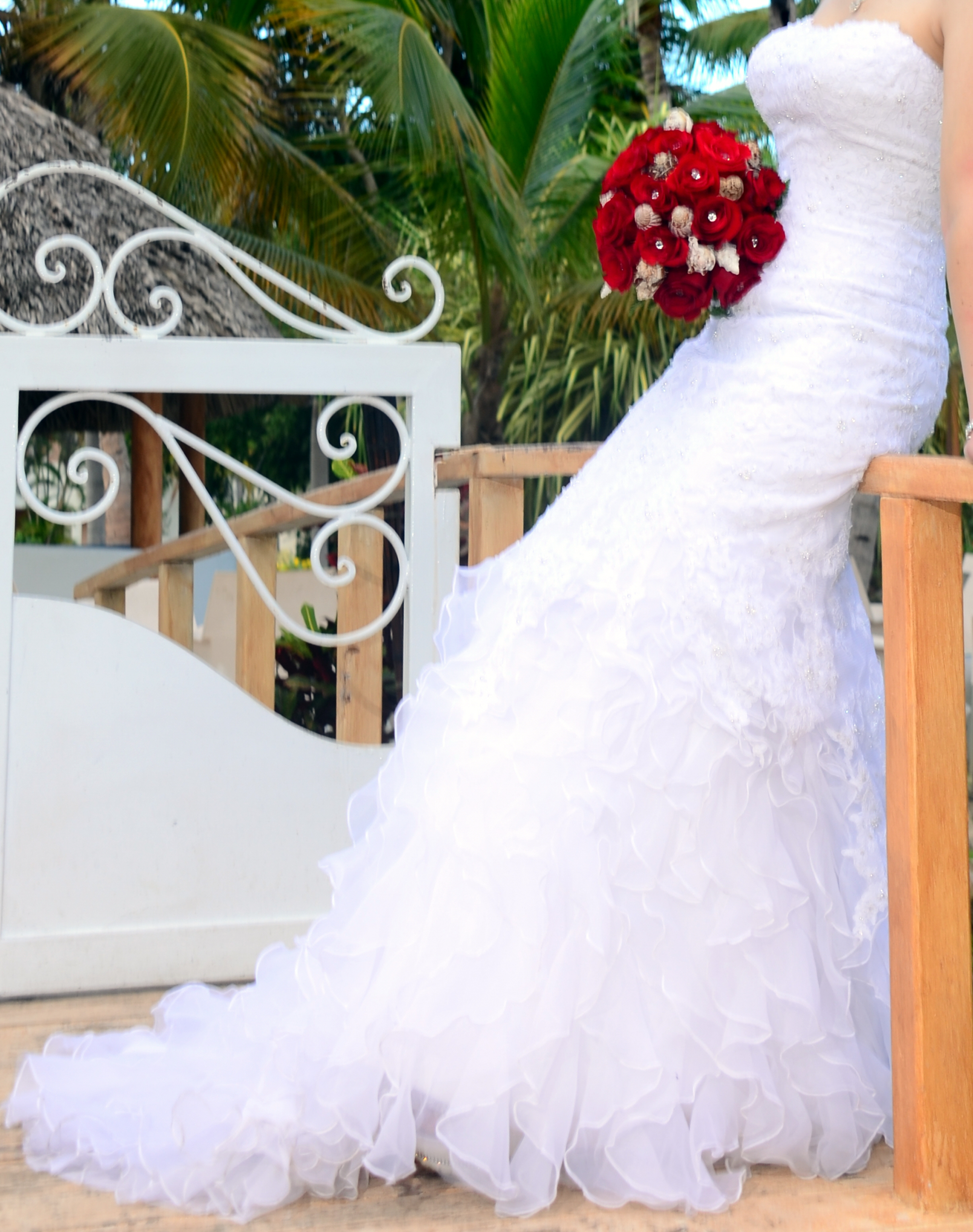 Bridal gown with red rose bouquet