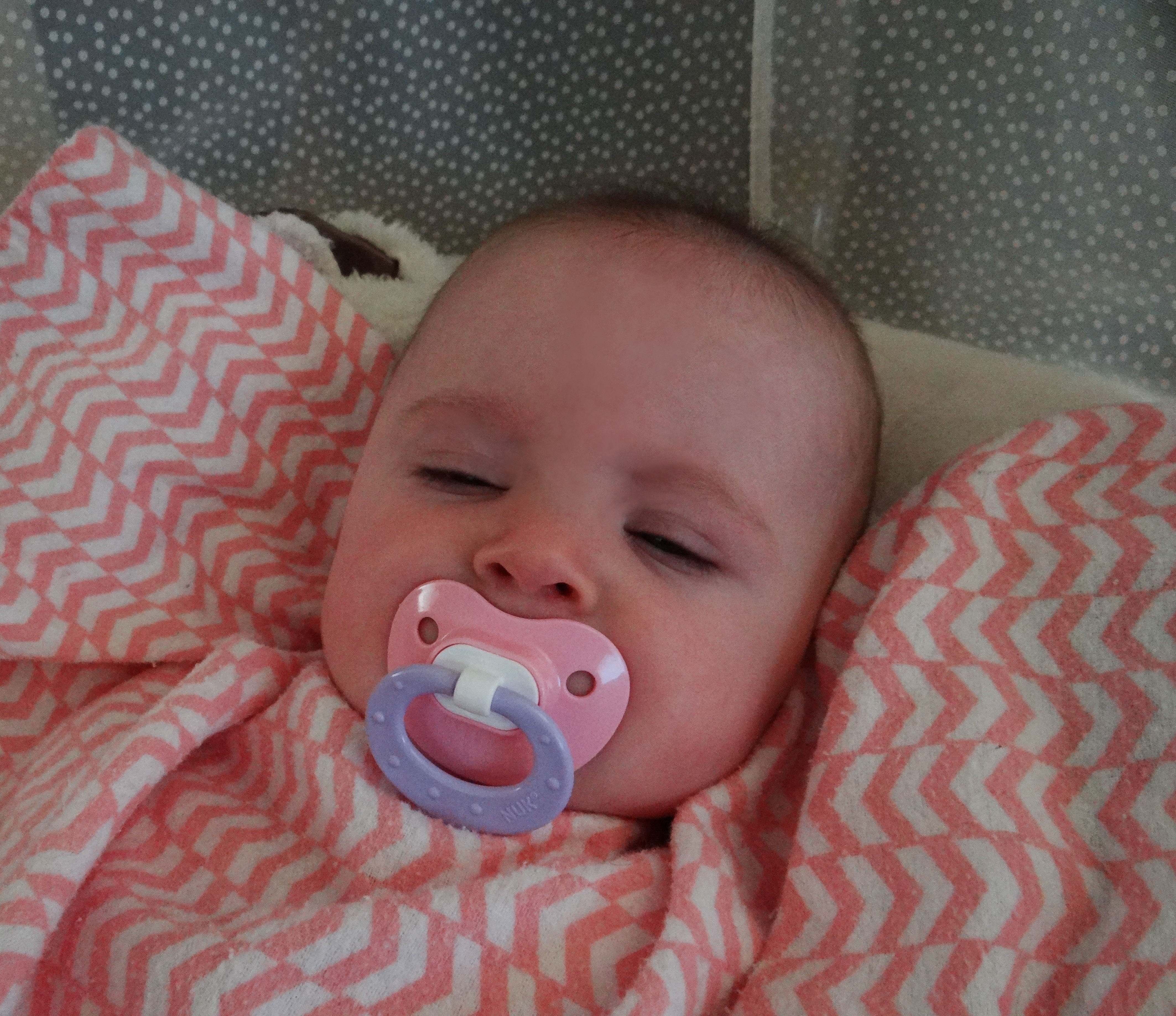 Baby having a nap with a pacifier