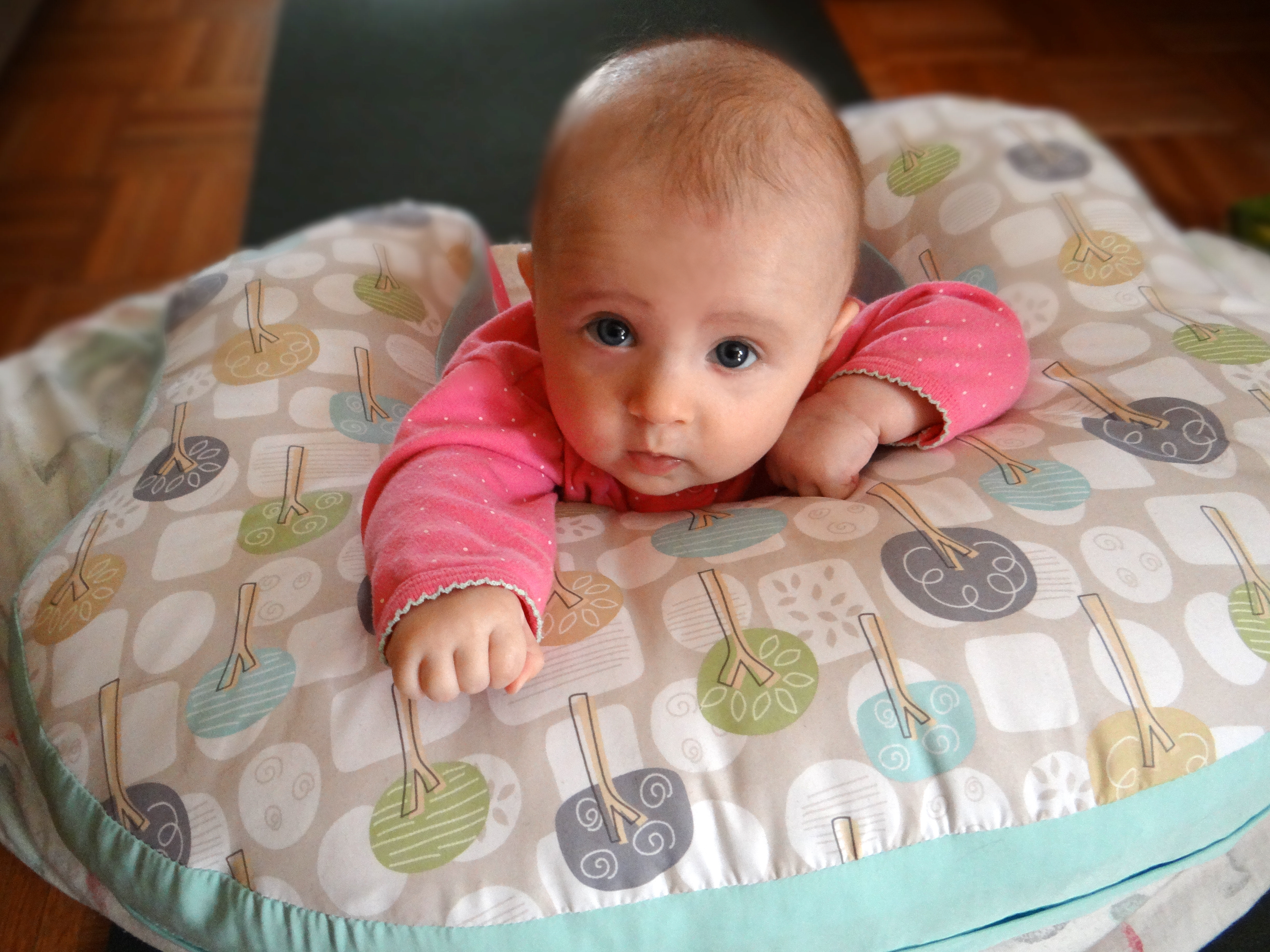 Tummy time with the use of a nursing pillow.