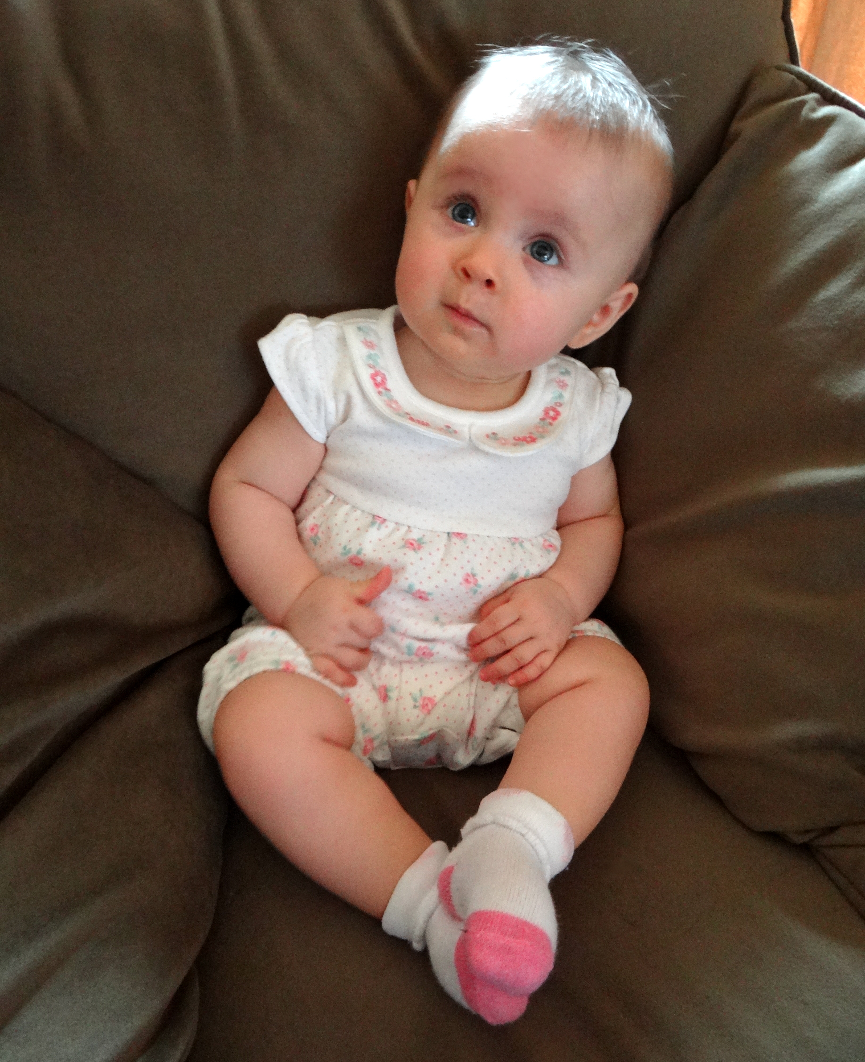 Baby girl sitting on a couch
