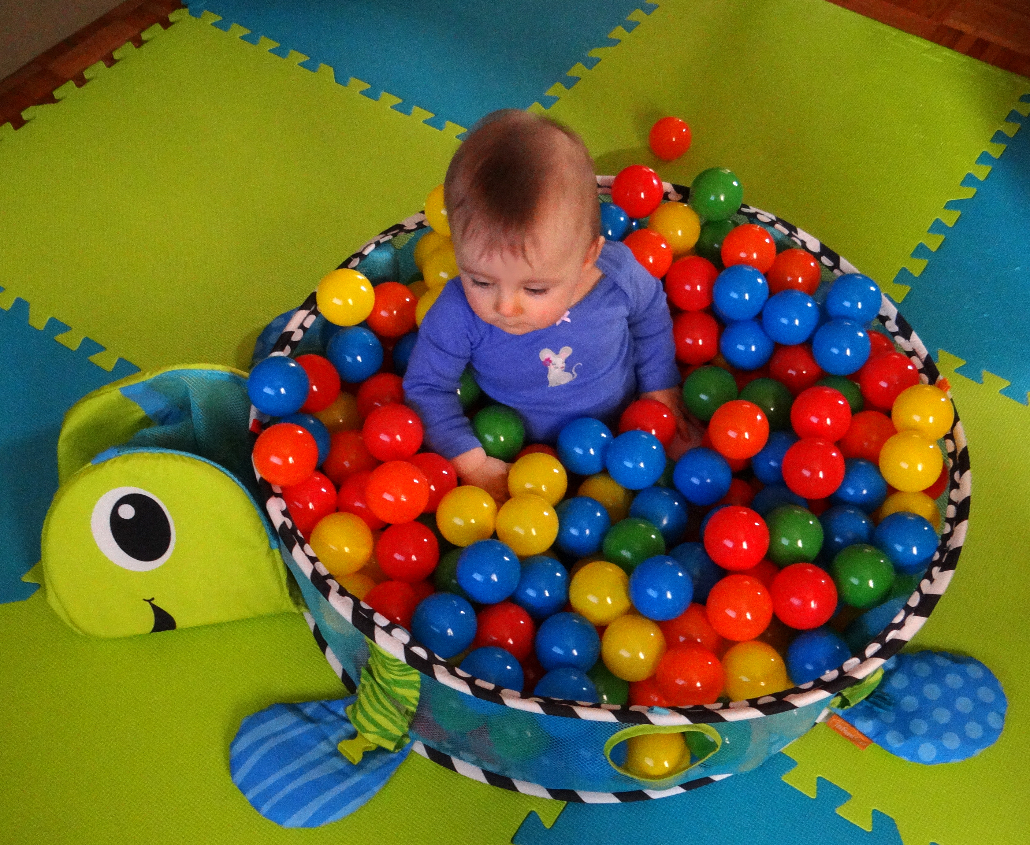 Baby in the Infantino Grow-With-Me Activity Gym & Ball Pit