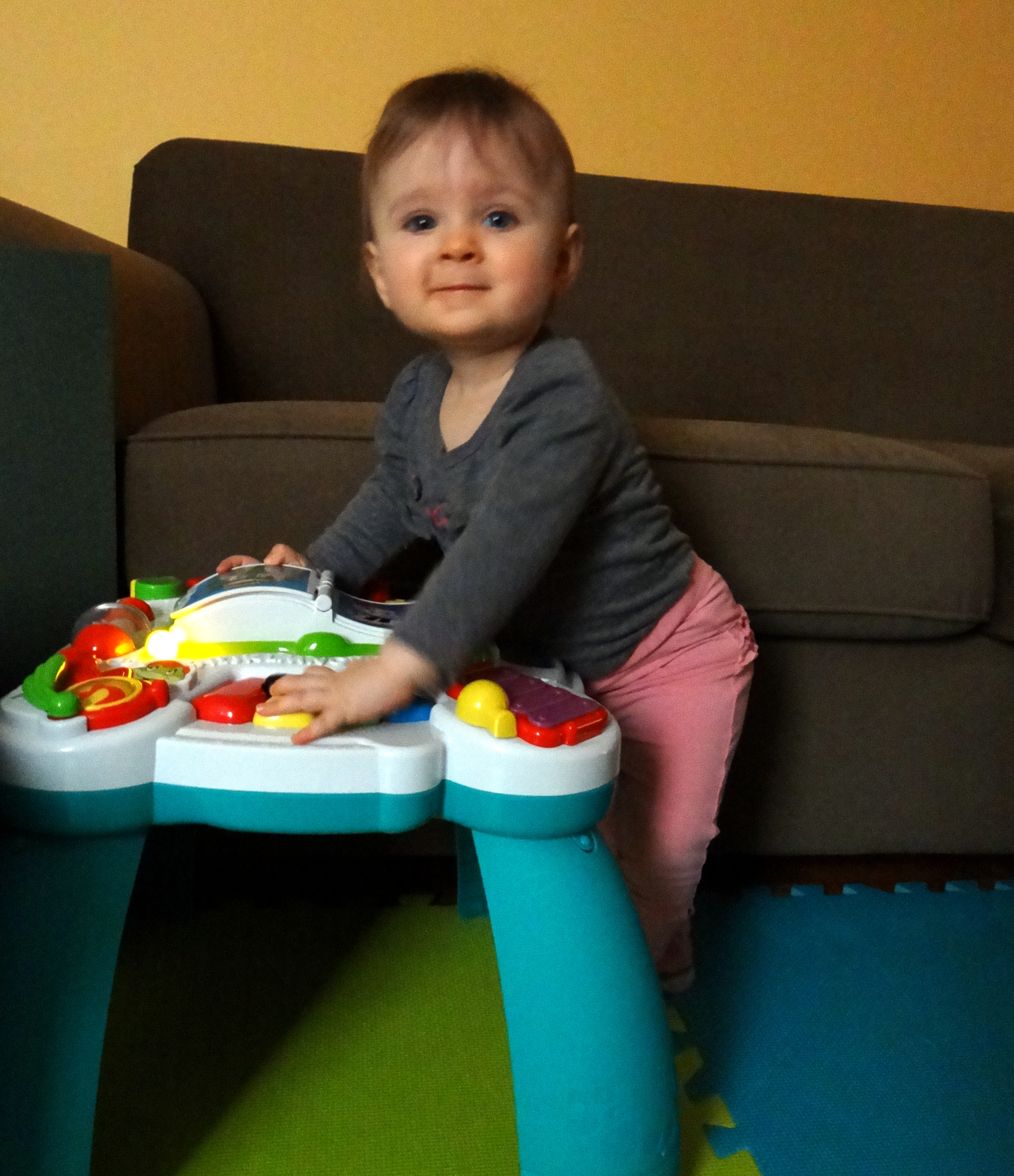 Baby standing at a play table