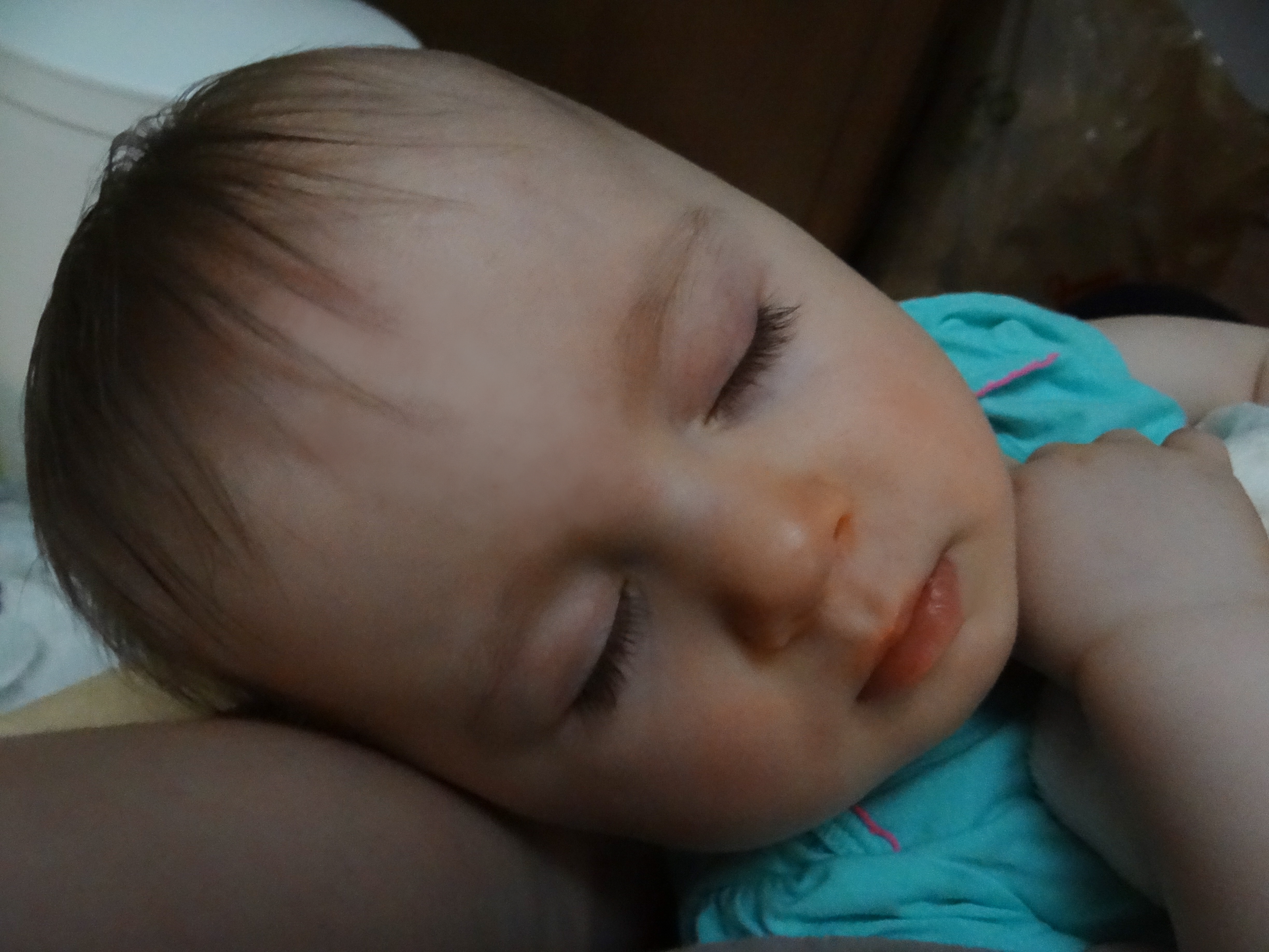 Baby girl asleep in mommy's arms