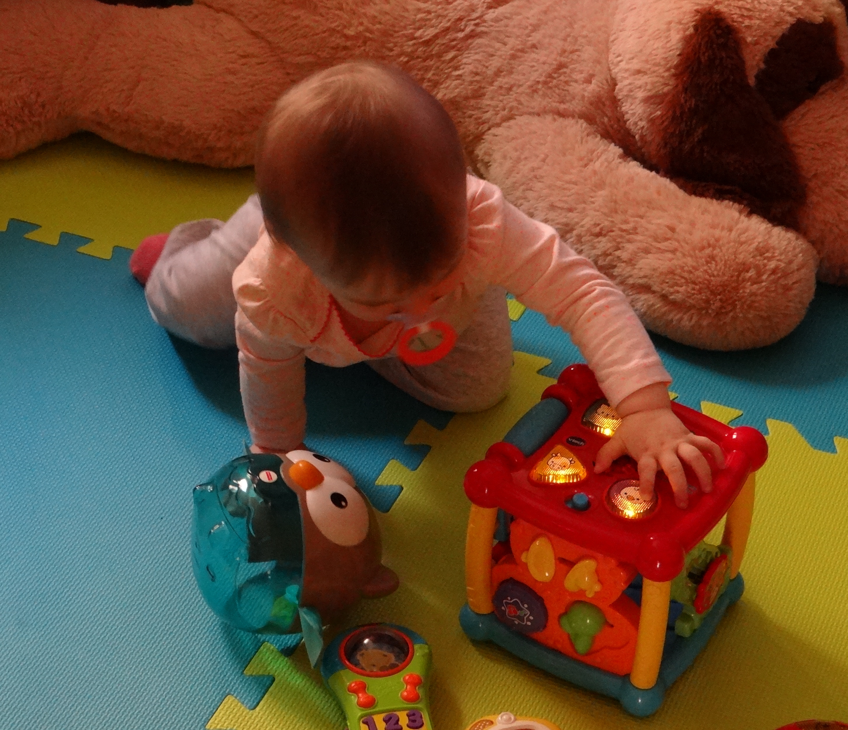 Baby playing with a Vtech toy.