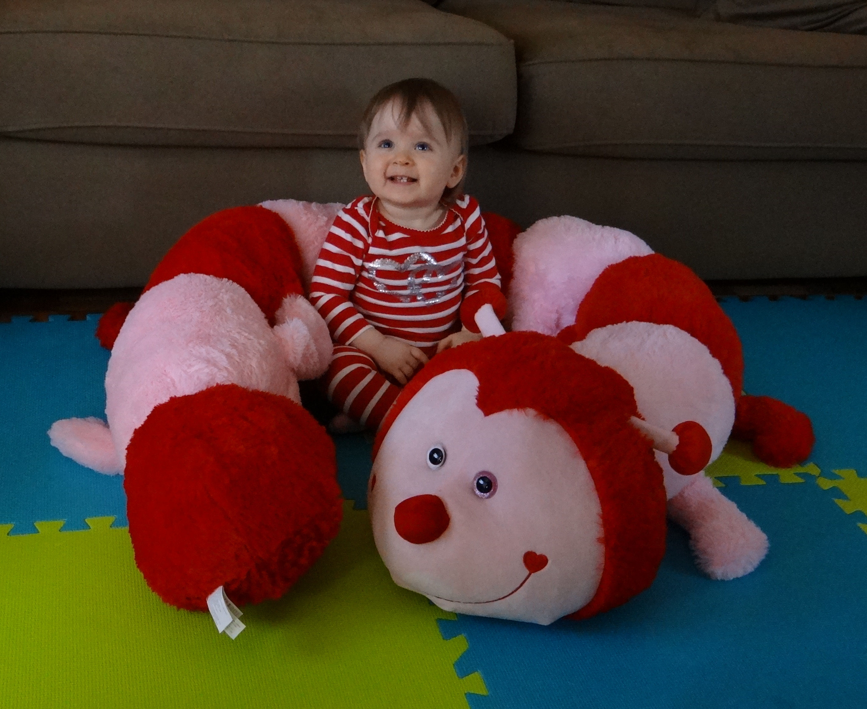 Baby with a giant stuffed caterpillar for Valentine's Day