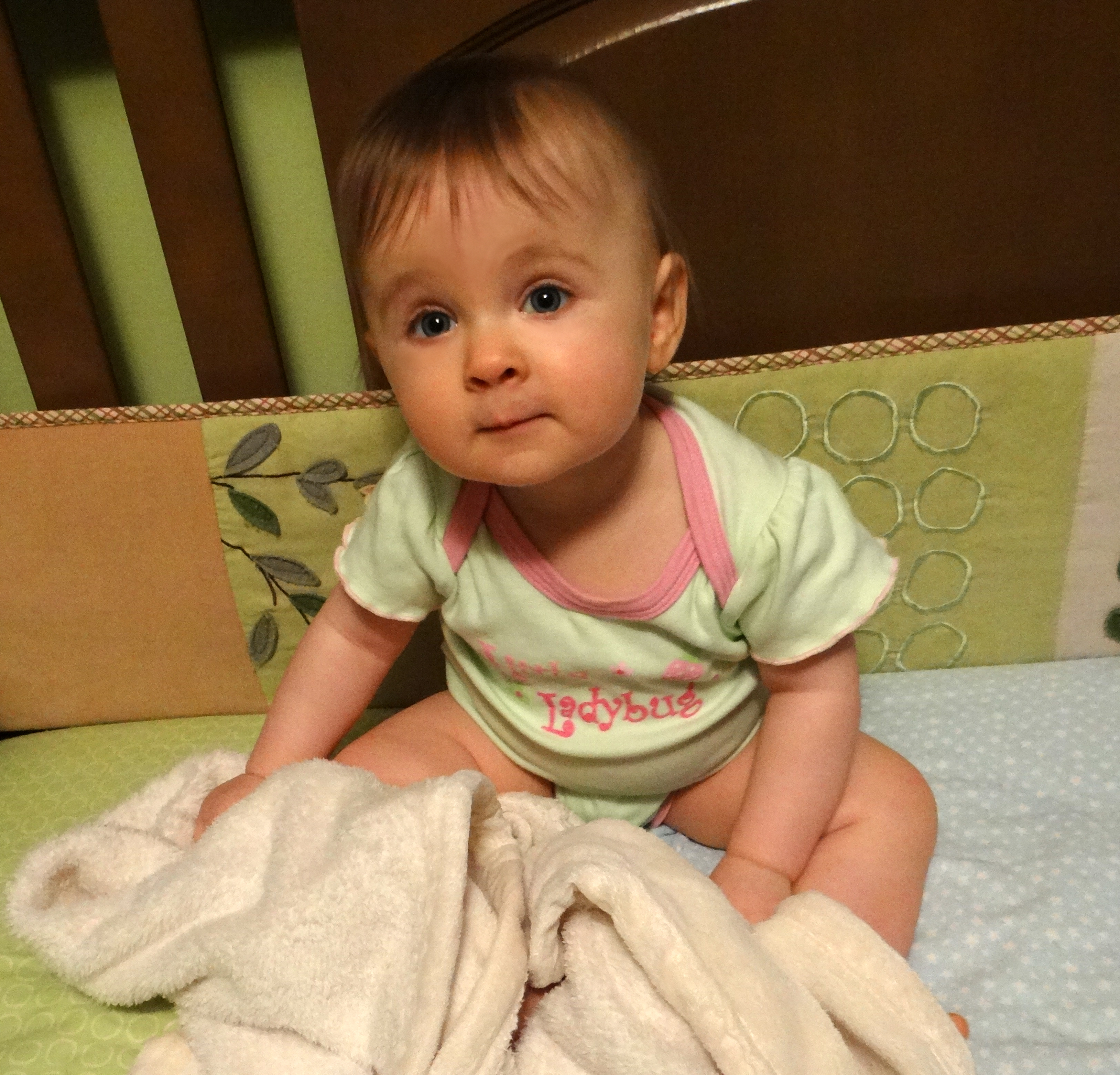 Baby sitting in a crib