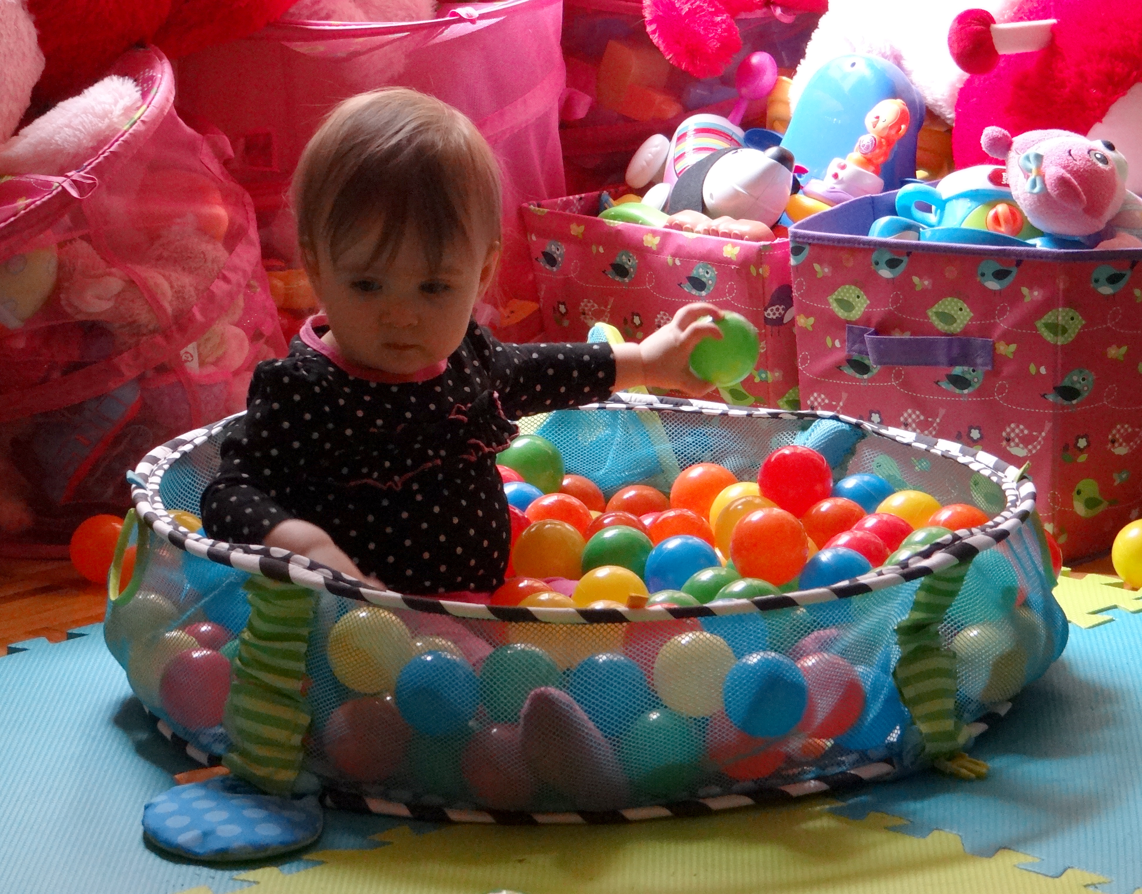 Baby playing in a ball pit